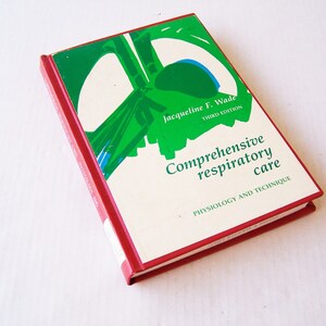 Pode incluir: Um livro vermelho e branco intitulado "Comprehensive respiratory care: physiology and technique" de Jacqueline F. Wade, terceira edição. A capa apresenta um design abstrato de formas verdes e azuis.