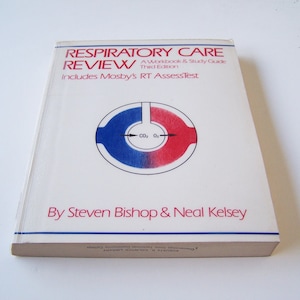 May include: A white book with a blue and red circle on the cover. The book is titled "Respiratory Care Review: A Workbook & Study Guide, Third Edition." The book also says "Includes Mosby's RT AssessTest" and "By Steven Bishop & Neal Kelsey".