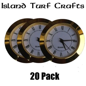 May include: A pack of 20 gold-rimmed clock faces with white backgrounds and black Roman numeral hour markers. The clock faces are labelled "QUART" and have black hands.