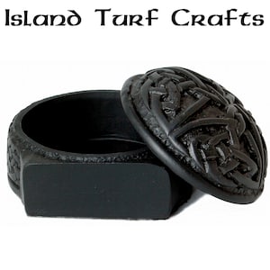 May include: Black Celtic knot design trinket box with a hinged lid. The box is made of resin and has a detailed, intricate design.