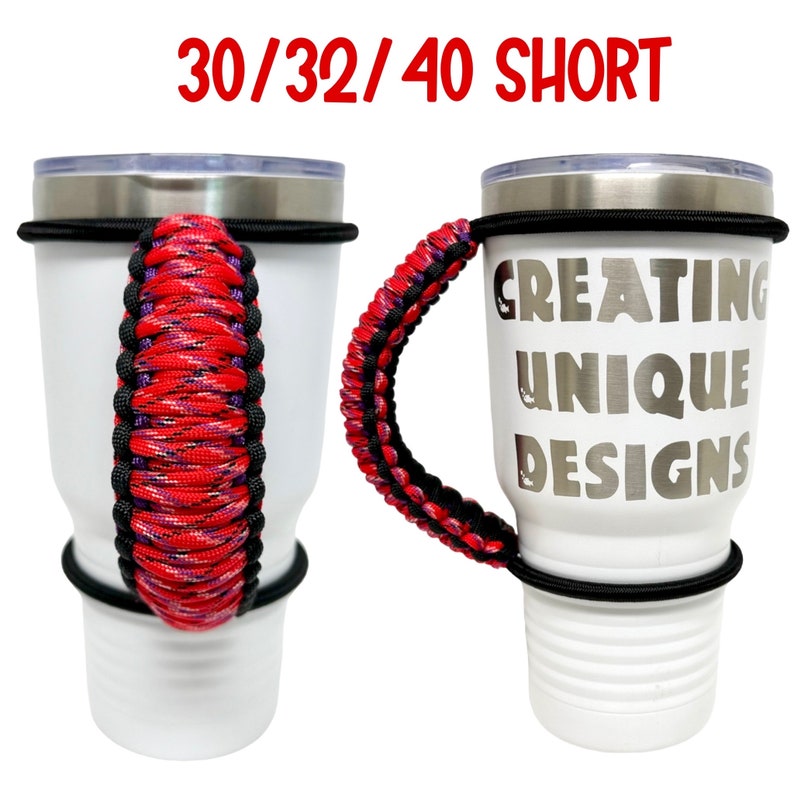 May include: Two white tumblers with black lids and black rubber bands. The tumbler on the right has the text "Creating Unique Designs" printed on it. Both tumblers have a red, black, and purple paracord handle.