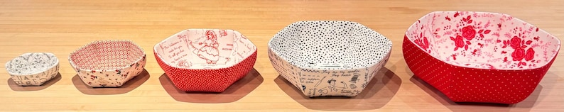 May include: Five fabric bowls in various sizes and patterns. The bowls are red, white, and black with floral and geometric designs.