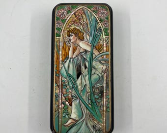 May include: Rectangular decorative box featuring an Art Nouveau design. The box has a black border and a central image of a woman in a flowing gown, surrounded by floral and botanical elements in shades of green, pink, and gold. The artist's signature is visible.