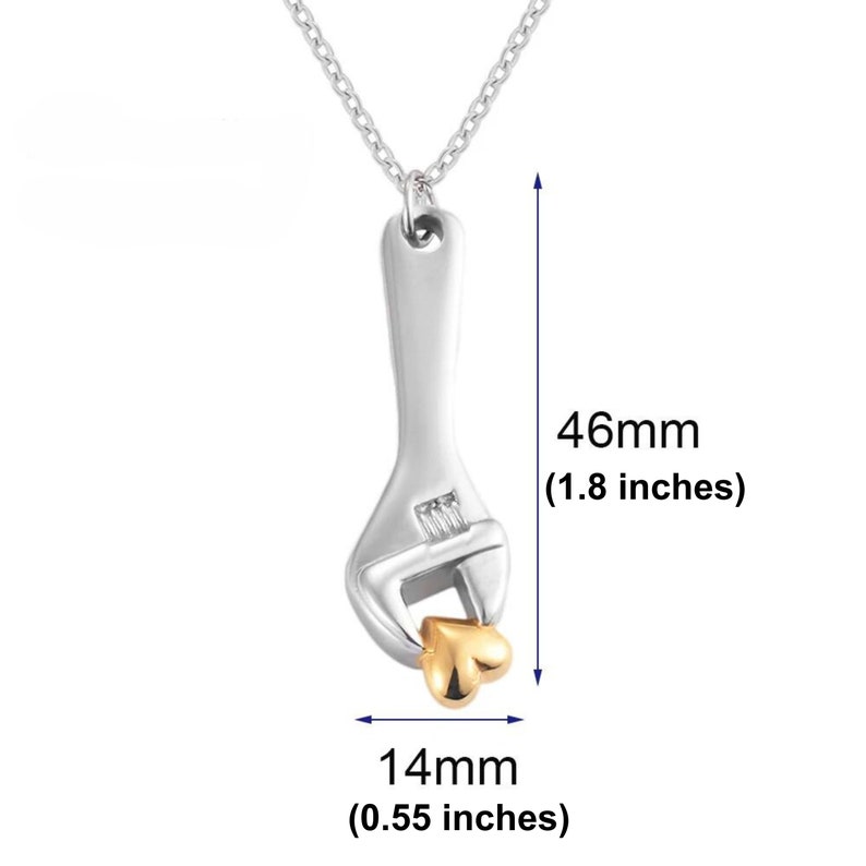 May include: Silver necklace with a wrench pendant holding a gold heart. The pendant is 1.8 inches tall and 0.55 inches wide.