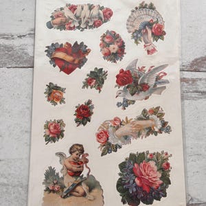 May include: A sheet of vintage-style stickers featuring various romantic designs. The stickers include images of doves, roses, hearts, cherubs, and hands holding fans. The text on the packaging reads "8 sticker sheets - all the same designs."