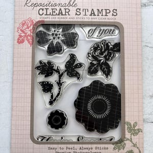 May include: A package of clear stamps featuring floral designs and the phrase "of you." The stamps are repositionable and made of premium photo-polymer. The packaging includes the text "Exclusive Collection" and "Made in the USA."