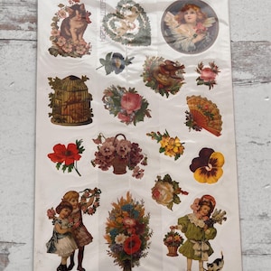 May include: A sheet of Victorian Fancy stickers featuring various vintage illustrations. Designs include angels, flowers, children, a cat, and a birdcage. The stickers are printed in the U.S.A. and include the text "CODE 60107".