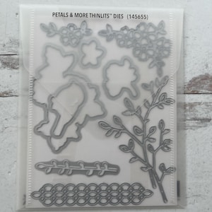 May include: A set of three ceramic mugs with a speckled, matte finish. The mugs are in shades of cream, light gray, and dark gray. Each mug has a simple, minimalist design, perfect for coffee or tea.