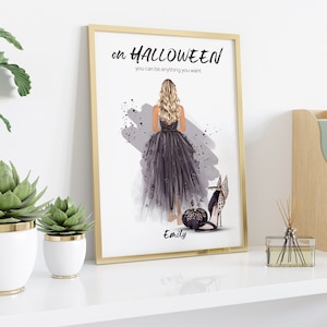 May include: A framed print with a watercolor illustration of a woman in a black dress and high heels. The text on the print reads "On Halloween you can be anything you want." The woman's name, "Emily", is written below the illustration.