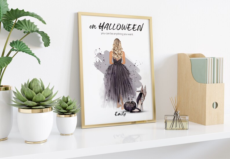 May include: A framed print with a watercolor illustration of a woman in a black dress and high heels. The text on the print reads "On Halloween you can be anything you want." The woman's name, "Emily", is written below the illustration.
