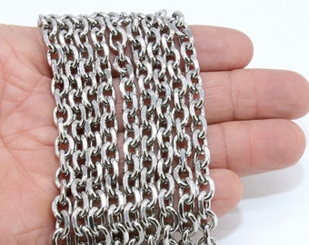 Op de afbeelding: Een zilveren ketting met meerdere strengen, getoond op een hand. De ketting is gemaakt van kleine, ovale schakels.