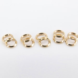 May include: Six gold jump rings, each with a diameter of approximately 1/2 inch.
