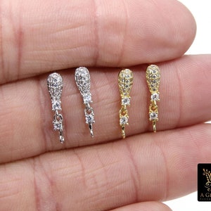 May include: Four pairs of dangle earring findings with clear cubic zirconia stones. The findings are available in silver, gold, and rose gold.