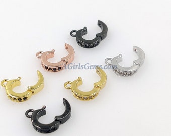 May include: Five different colored metal clasps with a row of clear cubic zirconia stones. The clasps are in black, gold, silver, rose gold, and gunmetal.