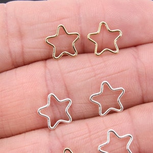 May include: Six silver and gold star-shaped jump rings. The jump rings are open and ready to be used for jewelry making.