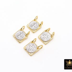 May include: Four gold-toned square pendants with silver-colored coin inserts. Each pendant has a loop at the top for attaching to a chain or bracelet. The pendants are arranged on a white background.