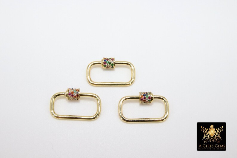 May include: Three gold-toned rectangle-shaped clasps with a colorful jeweled cylinder in the center of each clasp.