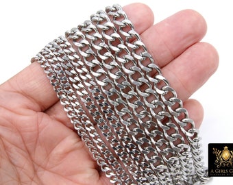 May include: A close-up of a set of silver curb chains of varying widths. The chains are laid out in a fan shape on a hand.