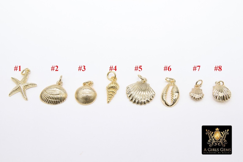 May include: Eight gold-toned charms in the shape of seashells and a starfish. The charms are numbered 1 through 8.