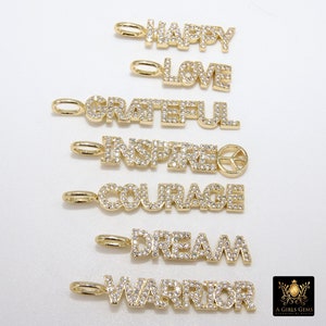 May include: Seven gold charms with diamond-like accents spelling out the words "Happy", "Love", "Grateful", "Inspired", "Courage", "Dream", and "Warrior".