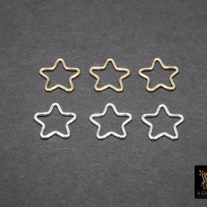 May include: Six star-shaped metal hoops, three gold and three silver, arranged in two rows of three.