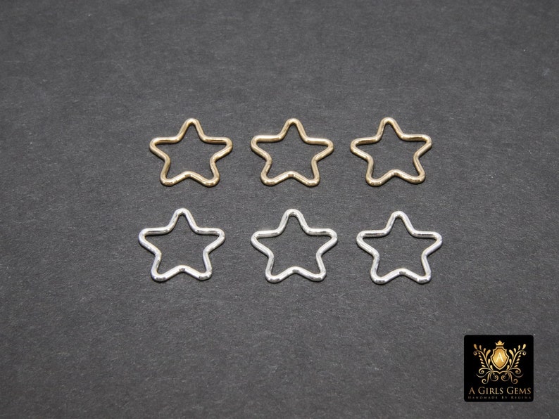 May include: Six star-shaped metal hoops, three gold and three silver, arranged in two rows of three.
