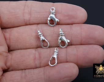 May include: Four silver-toned lobster claw clasps, commonly used for jewelry making.