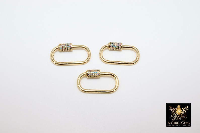 May include: Three gold-toned metal clasps with colorful rhinestones. Each clasp is oval-shaped with a cylindrical section in the center.