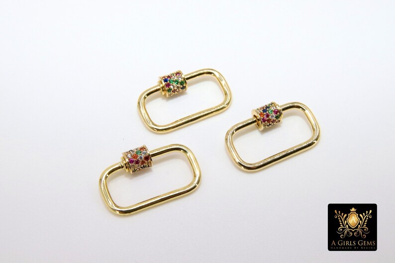 May include: Three gold-toned rectangle-shaped clasps with a colorful jeweled cylinder in the center of each clasp.