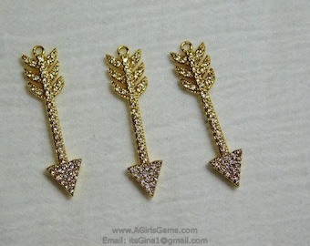 May include: Three gold arrow charms with clear rhinestone accents. The arrows are approximately 2 inches long.