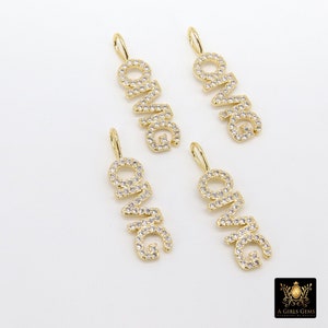May include: Four gold-tone pendants with the word "OMG" spelled out in clear cubic zirconia stones. Each pendant has a loop at the top for attaching to a chain.