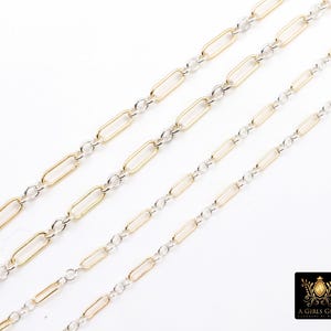 May include: Four strands of jewelry chain with alternating gold and silver links. The gold links are elongated ovals, and the silver links are small circles. The chains are displayed diagonally against a white background.