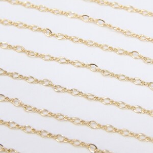 May include: Multiple strands of gold chain, a delicate, oval-link chain, perfect for jewelry making.