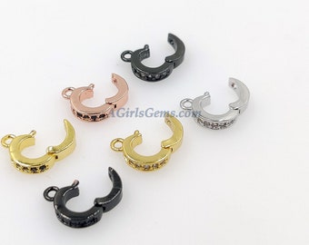 May include: Five different colored metal clasps with a row of clear rhinestones. The clasps are in black, gold, silver, rose gold, and gunmetal.