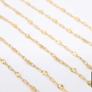 May include: Five gold chains with a delicate, patterned design. Each chain features small, round links with a textured surface.