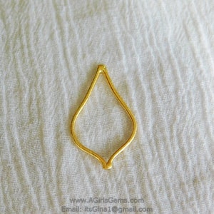 May include: Gold-toned metal pendant shaped like a teardrop with a delicate, openwork design.