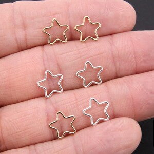 May include: Six silver and gold star-shaped jump rings. The jump rings are open and ready to be used for jewelry making.