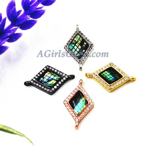 May include: Four diamond-shaped pendants with abalone shell inlays and clear crystal accents. The pendants are in black, silver, gold, and rose gold finishes.