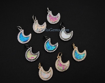 May include: Assortment of nine crescent moon shaped pendants with opal inlay and clear crystal accents. The pendants are silver, gold, and black.