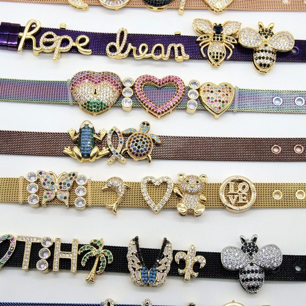 May include: A collection of gold-tone bracelets with various charms, including a heart, a bee, a turtle, a frog, a butterfly, a palm tree, a fleur-de-lis, and a teddy bear. The bracelets are made of a mesh metal and have different colored stones.