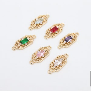 May include: Six gold-tone metal connector charms with different coloured rectangular gemstones. Each charm has a filigree design and two loops for attaching to jewellery.