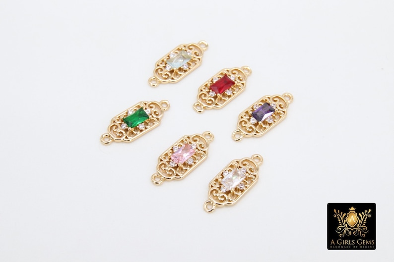 May include: Six gold-tone metal connector charms with different coloured rectangular gemstones. Each charm has a filigree design and two loops for attaching to jewellery.