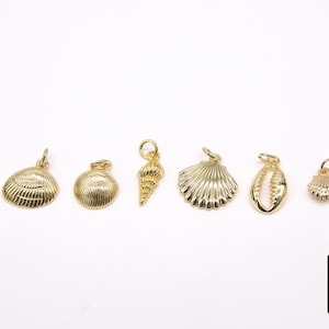 May include: A set of eight gold-toned metal charms featuring various seashell and starfish designs. The charms are perfect for adding a touch of nautical style to jewellery or crafts.