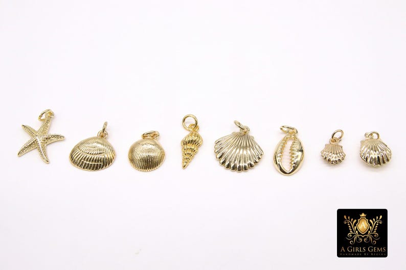 May include: A set of eight gold-toned metal charms featuring various seashell and starfish designs. The charms are perfect for adding a touch of nautical style to jewellery or crafts.