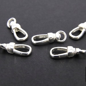 May include: Five silver-toned metal clasps or swivel hooks. The clasps are oval-shaped with a small loop at the top.