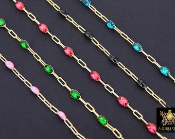 May include: Five gold chains with different colored oval-shaped beads. The beads are pink, green, and blue.