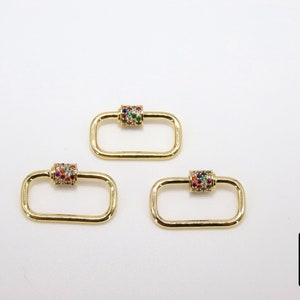 May include: Three gold-toned rectangle-shaped clasps with a colorful jeweled cylinder in the center of each clasp.