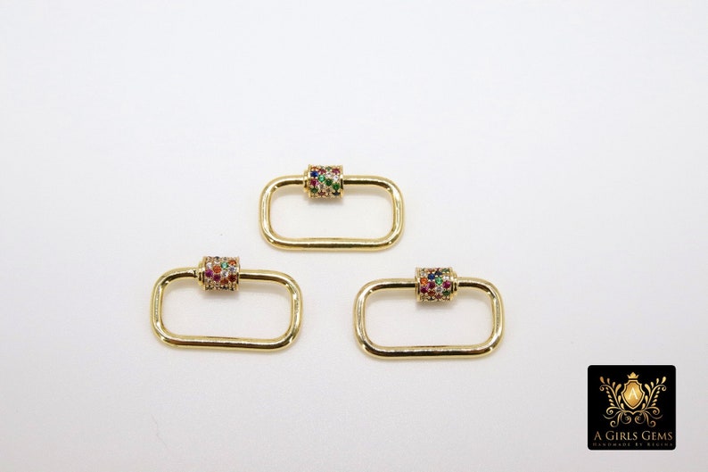 May include: Three gold-toned rectangle-shaped clasps with a colorful jeweled cylinder in the center of each clasp.