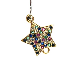 May include: Gold-tone star charm with a multi-colored crystal design. The charm has a loop for attaching to a necklace or bracelet.
