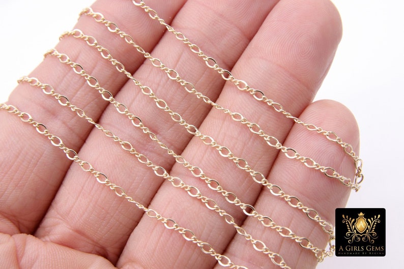 May include: A close-up of multiple gold chains, each with a different length and thickness. The chains are made of a delicate, twisted design.